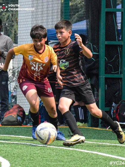 Two players battling for the ball during the Youth Championship 2024. This image captures the competitive spirit of the league.