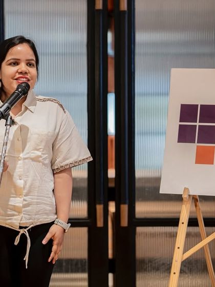 A performer stands confidently at the mic, contributing her voice to our celebration of women.