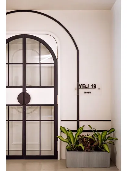 Another view of the entrance, with the custom nameplate and a simple planter. Every detail is carefully curated to create a welcoming and sophisticated first impression.