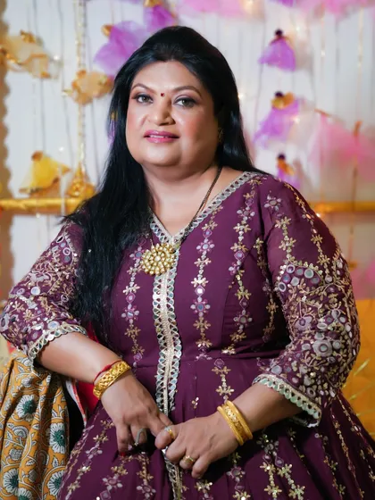 A smiling portrait of this gorgeous and dramatic look. The makeup enhances her features and adds a touch of glamour.