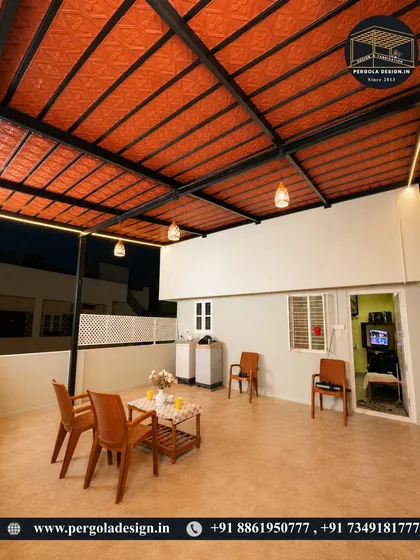 A cozy rooftop terrace at night, illuminated by warm lighting. The Mangalore tile roof provides excellent insulation and a traditional aesthetic, making the space comfortable and inviting for evening relaxation.
