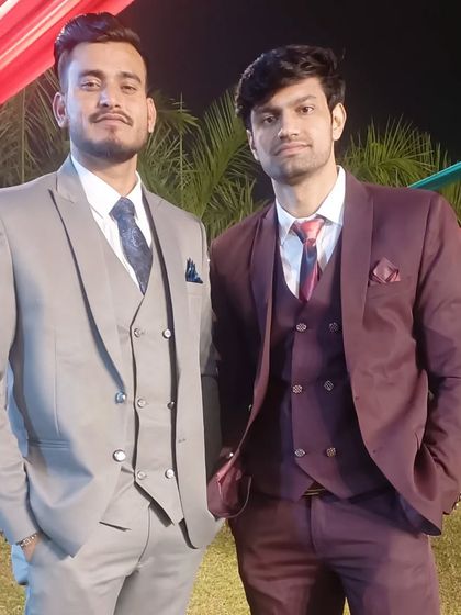 With my brother at a family function, both dressed in formal suits.