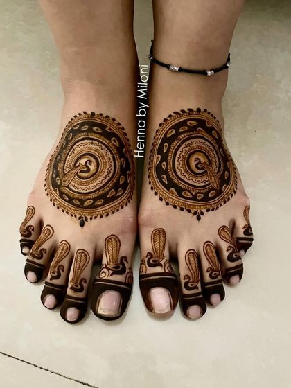 A bold and modern design for the feet, with a large circular peacock motif and matching patterns on the toes.