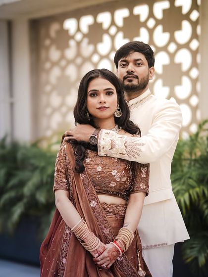 An elegant engagement portrait with the groom's arm gently around his fiancée.
