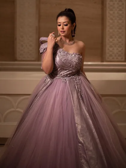 A full-length view of the royal lavender ball gown, showing its grand silhouette and modern, asymmetrical design. It's a perfect choice for a bride who wants a unique and memorable look.