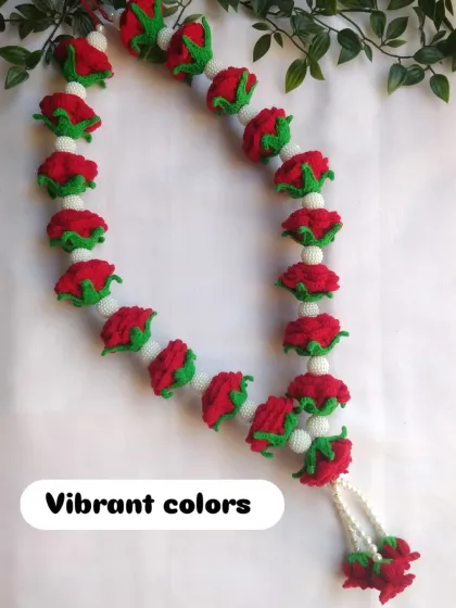 The vibrant red of the roses contrasts beautifully with the white crochet beads. This garland is designed to look full and luxurious, perfect for a wedding ceremony or as a special offering.