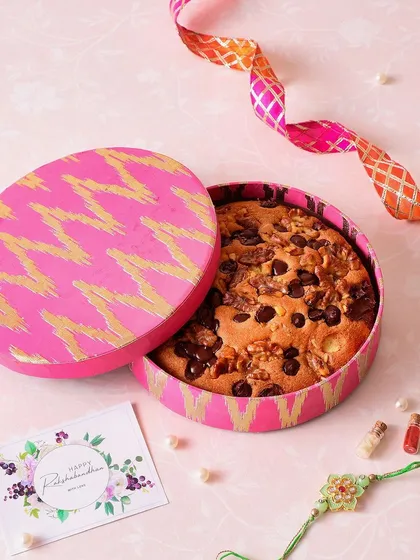 Our Walnut Chocolate Travel Cake is perfect for sending to a sibling who lives far away. It's delicious, travels well, and comes in this vibrant pink Ikat box.