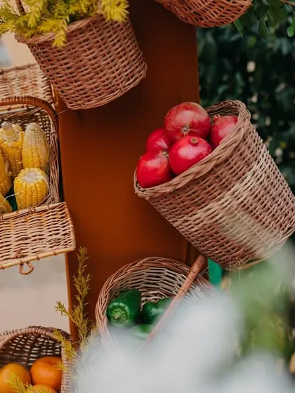 Baskets of fresh fruits and vegetables used as decor elements, bringing the 'Farmer's Market' theme to life.