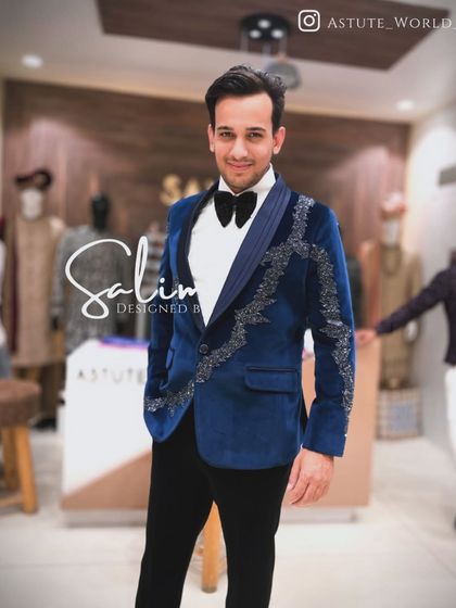 A client in a royal blue velvet tuxedo with abstract silver sequin work on the lapel and shoulder. The rich color of the velvet makes the silver details pop.