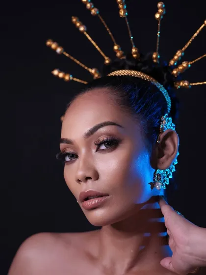 A close-up that captures the intensity of the look and the beautiful details of the headpiece.