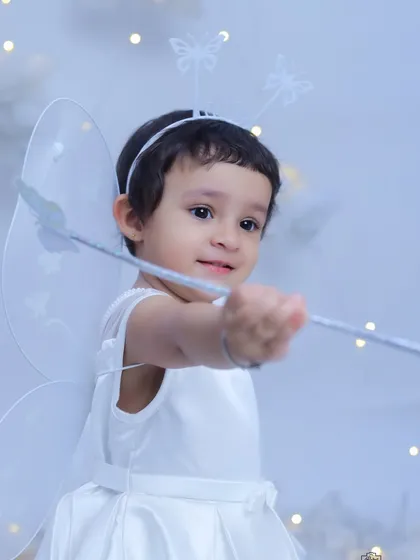A close-up of our little fairy, pointing her magic wand. We love capturing the wonder and imagination of childhood in these enchanting themed shoots.