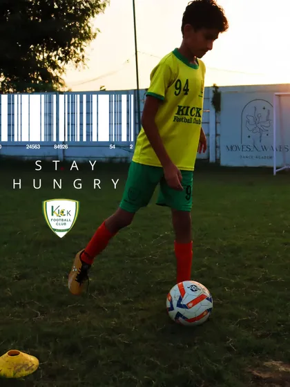 Stay hungry. A player focuses on the ball during a drill, embodying the drive and ambition we encourage.