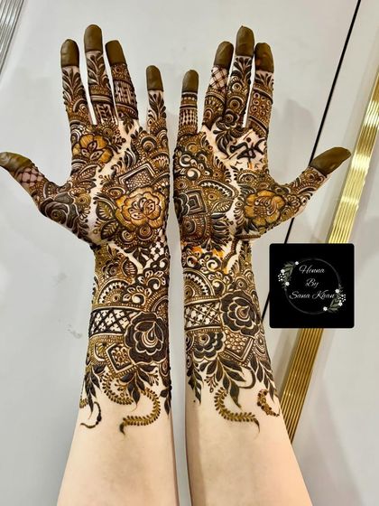 This full-arm design combines bold roses with delicate checkerboard patterns and leafy vines, creating a rich and textured bridal look.