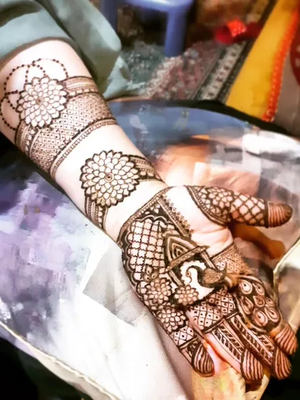 A unique Eid design with large mandala-style flowers on the arm.
