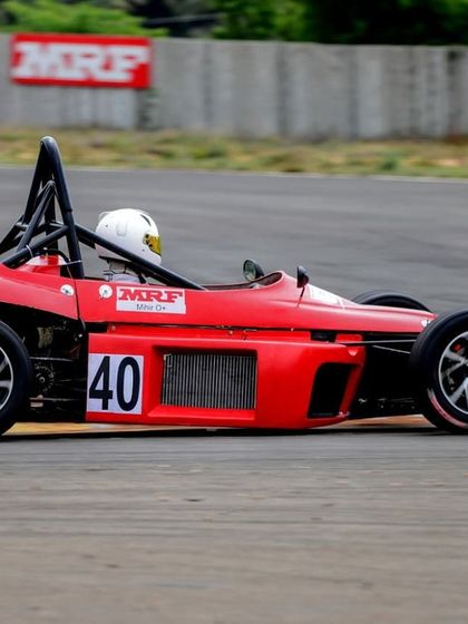 The number 40 car at speed on the main straight, with the MRF branding visible, a key partner in Indian motorsport.
