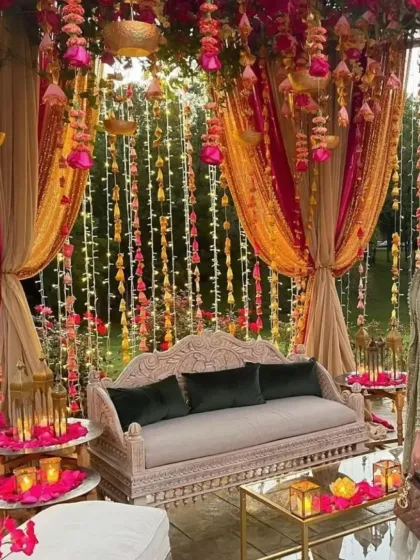 The details are what make an event truly special. This photo shows a cozy and luxurious seating area I designed for a wedding, featuring intricate furniture, plush velvet cushions, and cascading floral arrangements with warm candle lighting.