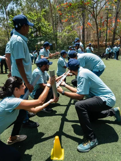 Teamwork in action. Colleagues collaborate closely during the Pipeline challenge, ensuring the ball doesn't drop.