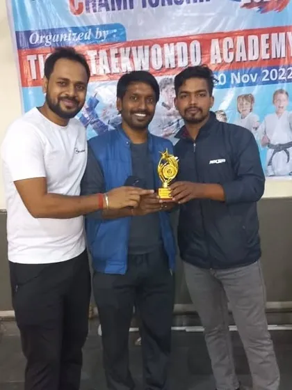 Receiving the team trophy with fellow coaches. A proud moment for all of us.