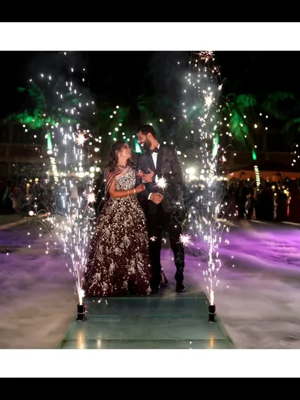 A grand reception entrance that feels like a movie scene. With dramatic lighting and fireworks, I make sure the celebration is captured with all the glamour and excitement it deserves, creating stunning nighttime wedding photos.