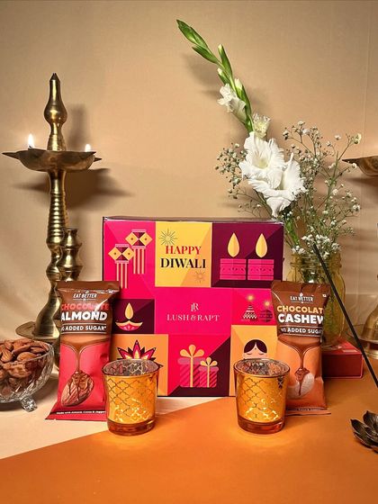 Another beautiful arrangement of our budget-friendly Diwali hamper, including festive T-light holders and healthy snacks.