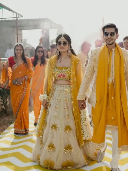 Nothing makes me happier than seeing my clients shine. Here's a beautiful couple in their custom coordinated Haldi outfits, ready to make an entrance. I love creating twinning looks that tell your story together.