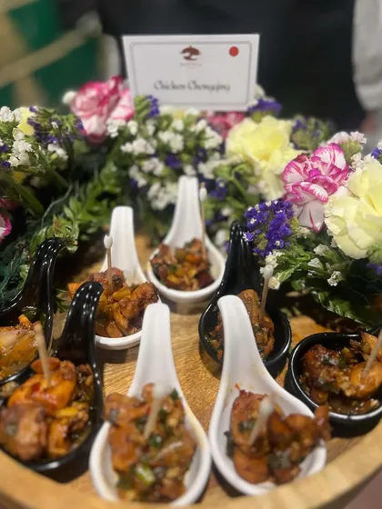 Chicken Chongquing, a spicy and flavourful bite-sized appetizer. We serve it in individual tasting spoons, making it easy for guests to enjoy while mingling. This dish is a highlight of our Pan-Asian catering menu.