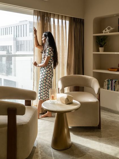 Here is a soothing corner that blends soft neutrals, modern lines, and curated accents. From the plush seating to the minimal shelves, every element is designed to elevate everyday living and create a space for quiet luxury.