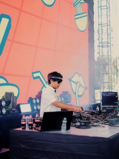 A side profile shot of me focused on the decks during my Zomaland performance. It's all about reading the crowd and dropping the right track at the right time.