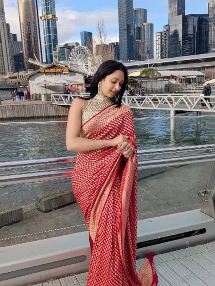 I love seeing our heritage travel the world. This exquisite red Banarasi silk saree, worn by our client in Melbourne, shows how timeless elegance and traditional craftsmanship can make a statement anywhere on the globe.
