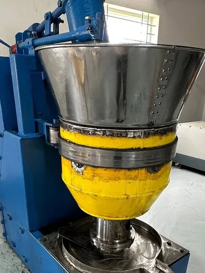 A close-up of our cold-press oil extraction machine. Using this ancient method allows us to create the high-quality, potent Ayurvedic oils that are the foundation of our services.
