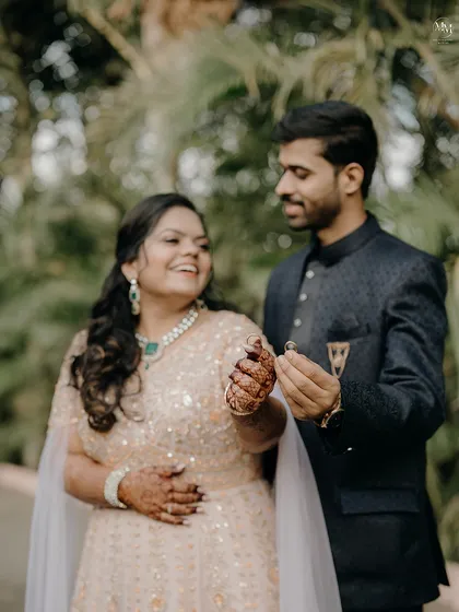 A happy, candid moment between Sayali and Anant as they show off their engagement rings. Their smiles truly light up the frame.