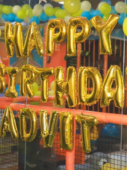 A personalized "Happy Birthday" banner hanging in the play zone. This ensures the birthday child feels celebrated even while they are busy playing with their friends.