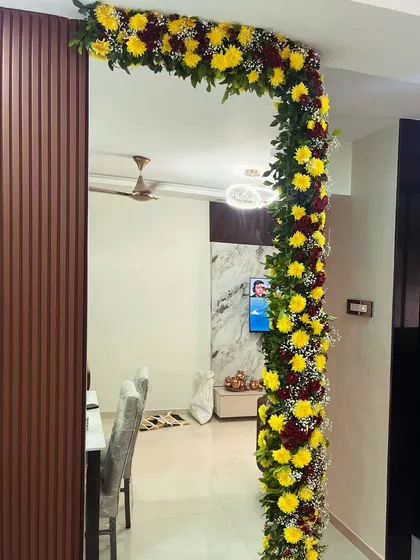 An interior view of the housewarming decor, showing how the floral garland frames the doorway inside the home, adding a touch of celebration throughout the space.