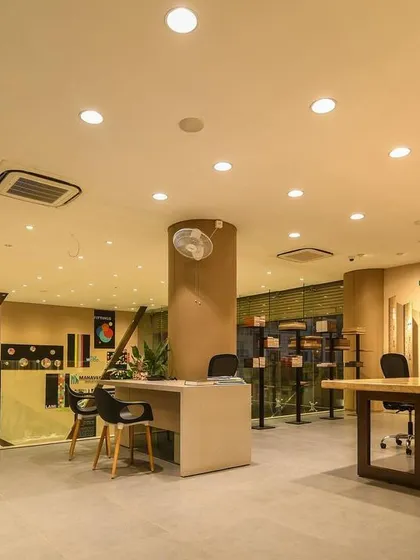 A comprehensive look at a conventional commercial space, highlighting the double-height reception, glass-walled mezzanine, and various product display areas designed for a modern business.