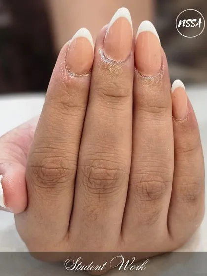 A perfect French manicure, one of the foundational skills every nail tech must master. Our students practice this until it is flawless.