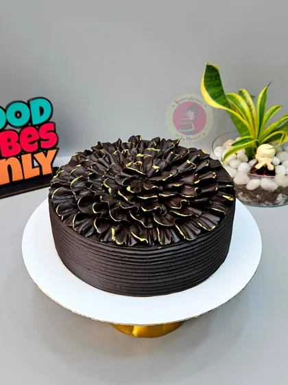 One of our bestseller designs. This rich chocolate truffle cake is decorated with a beautiful petal effect, created using a simple piping technique.