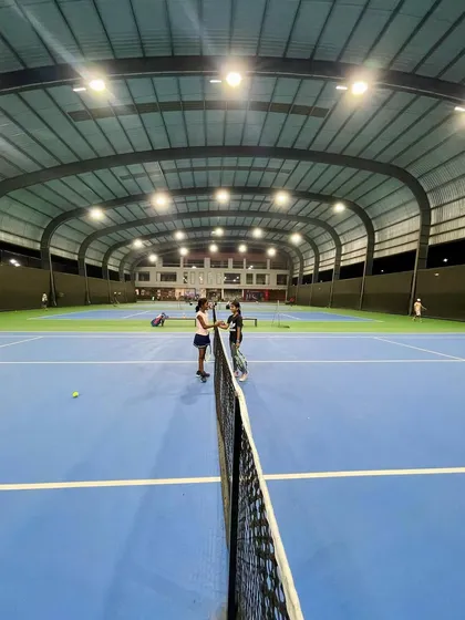 A wide view of our professional, covered hard courts during a UTR tournament. The state-of-the-art lighting and all-weather roofing ensure that training and competition can happen year-round, day or night.