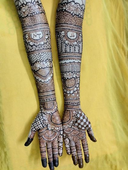 It was an honor to do this bridal henna for my cousin. I included her and her partner's initials, 'NT', in a special band on her arms.