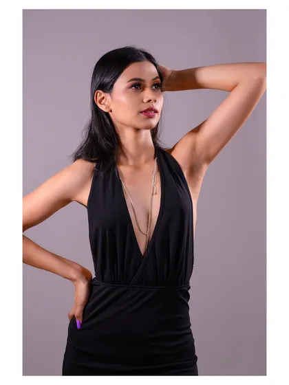 A close-up of the same look, allowing a better view of the delicate body chain and the model's expression.