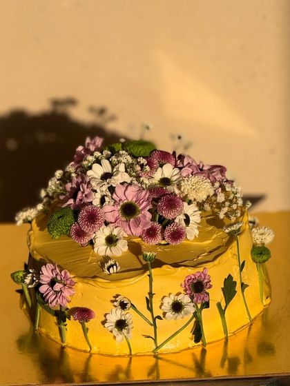 Another angle of the beautiful floral cake, showing the arrangement of fresh flowers on top and around the base. It’s a true celebration of nature.