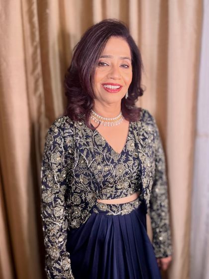 A smiling portrait of the elegant mother of the groom.