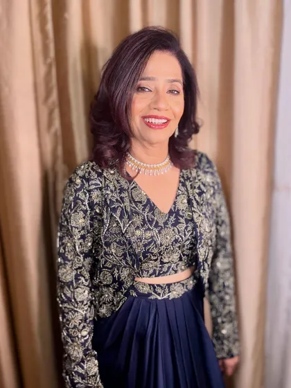 A smiling portrait of the elegant mother of the groom.