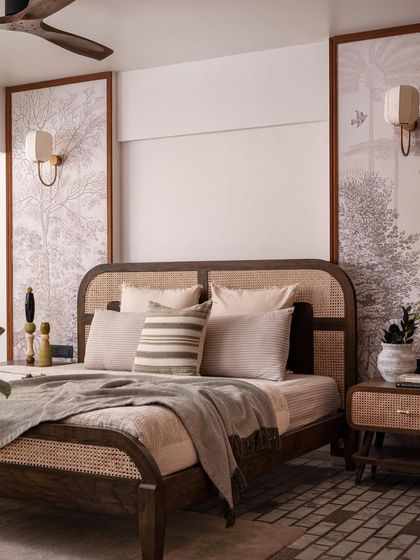 In our "Getaway to Galle" project, this bedroom features a custom bed with a beautiful cane headboard and footboard. The wall panels behind the bed are adorned with a subtle, tree-of-life wallpaper.