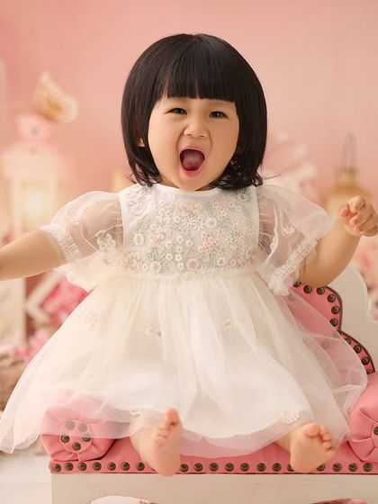 Capturing all the emotions of turning one, from big yawns to even bigger smiles. This expressive shot was taken right after her cake smash adventure.