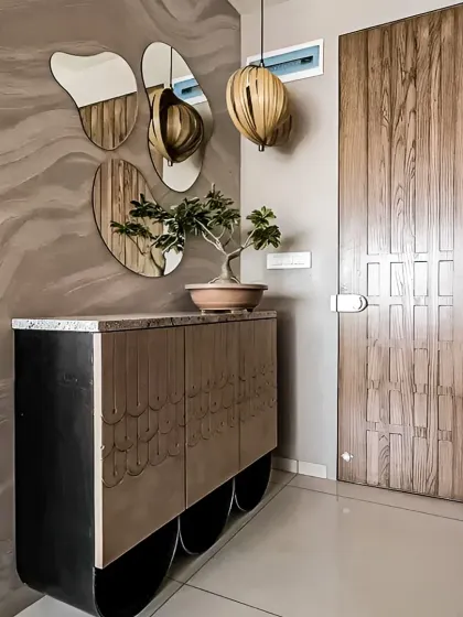 The entryway sets the tone for your entire home. I designed this space with a custom console table, unique pebble-shaped mirrors, and a statement wooden pendant light to create a warm and artistic first impression.