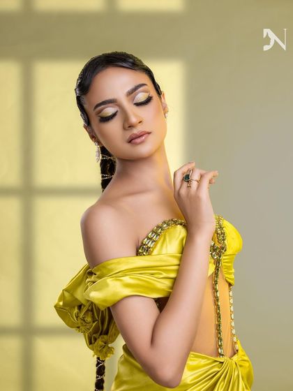 A close-up of the artistic makeup and the unique braided hairstyle.