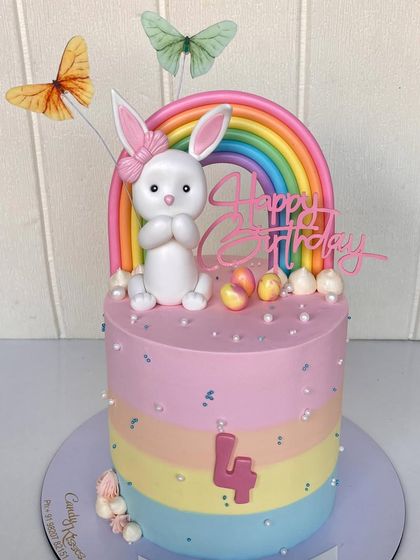 A pastel rainbow bunny cake made for a friend's daughter. This design features a cute bunny topper, a rainbow arch, and a surprise rainbow sponge inside.