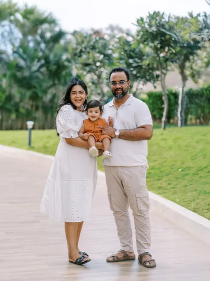 A happy family of three enjoying a walk outdoors. The first year flies by, and photos like these are a perfect way to freeze a moment in time.