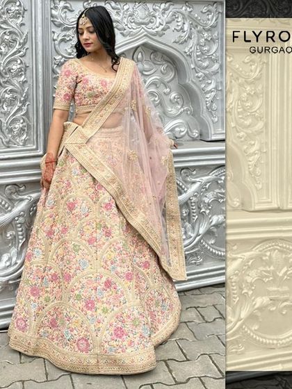 This stunning pastel lehenga features multi-colored floral embroidery, offering a fresh and modern take on bridal wear. It's perfect for a day wedding or engagement ceremony.