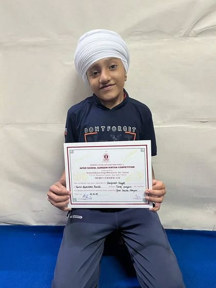 Jaspreet Singh holding his certificate for the Best Tabla Player Award at Shaheed Bishan Singh School, New Delhi.